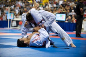 Brazilian Jiu-Jitsu athlete competing in a gi match during a local BJJ tournament, demonstrating control and technique.