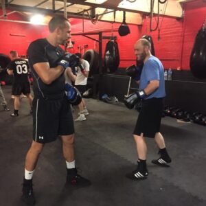 Two Raptors Muay Thai members practising a partner boxing drill, focusing on precision, timing, and technique inside the gym.